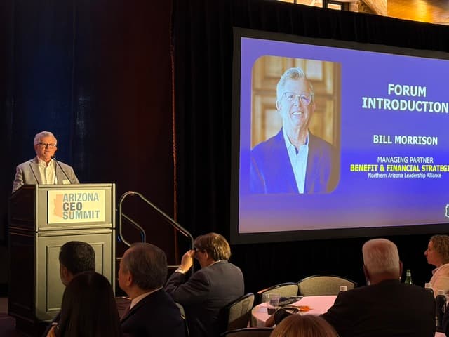 Bill Morrison speaking at an Arizona CEO Summit podium beside a screen reading Forum Introduction with his photo and name.